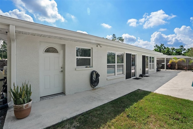 7304 Lakeside Blvd, Tampa, FL 33614 - rear view of house featuring a patio and stucco siding
