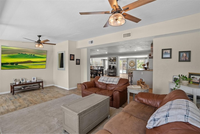 7304 Lakeside Blvd, Tampa, FL 33614 - living area featuring a ceiling fan, wood finished floors, and baseboards