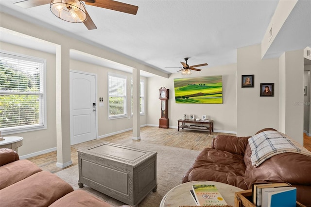 7304 Lakeside Blvd, Tampa, FL 33614 - living room with a ceiling fan, light wood finished floors, baseboards, and ornate columns
