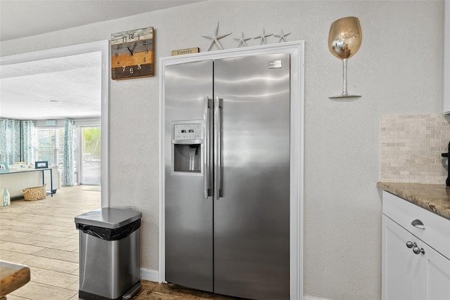 7304 Lakeside Blvd, Tampa, FL 33614 - kitchen featuring stainless steel fridge with ice dispenser, white cabinetry, and wood finished floors