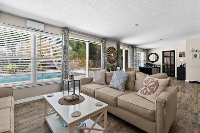 7304 Lakeside Blvd, Tampa, FL 33614 - living room featuring a textured ceiling, baseboards, and wood finished floors