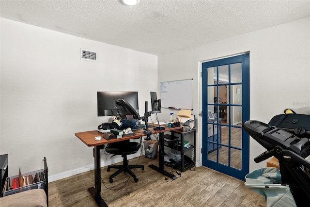 7304 Lakeside Blvd, Tampa, FL 33614 - office area with wood finished floors, a textured ceiling, and baseboards