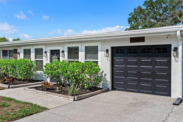 7304 Lakeside Blvd, Tampa, FL 33614 - view of front facade with an attached garage, concrete driveway, and stucco siding