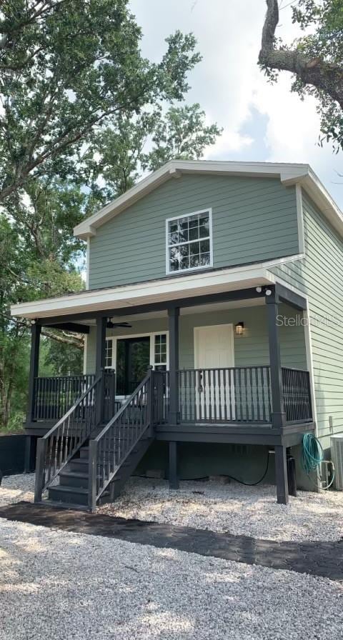 7152 Sandy Ln, Wesley Chapel, FL 33544 - view of front of home with a porch, cooling unit, and stairs