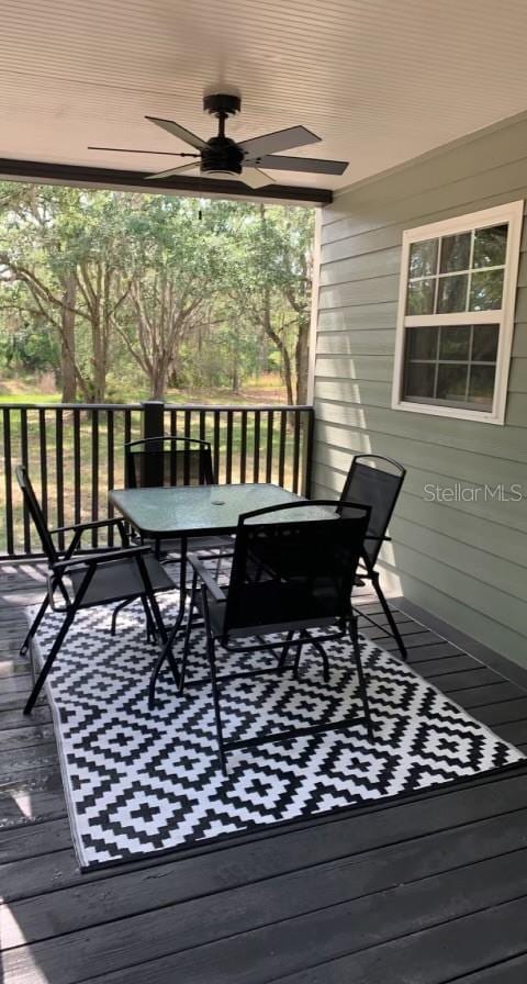 7152 Sandy Ln, Wesley Chapel, FL 33544 - deck with outdoor dining area and a ceiling fan
