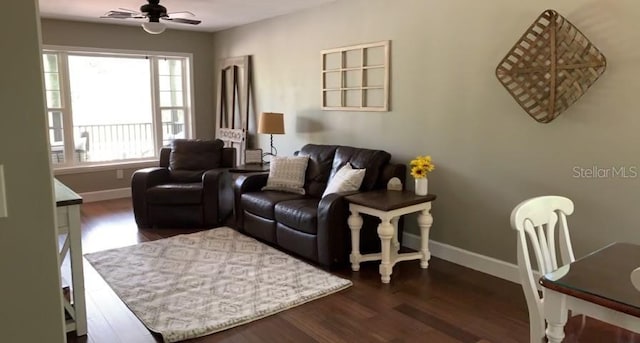 7152 Sandy Ln, Wesley Chapel, FL 33544 - living room featuring dark wood-style floors, a ceiling fan, and baseboards