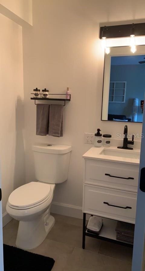7152 Sandy Ln, Wesley Chapel, FL 33544 - half bath featuring vanity, toilet, and baseboards