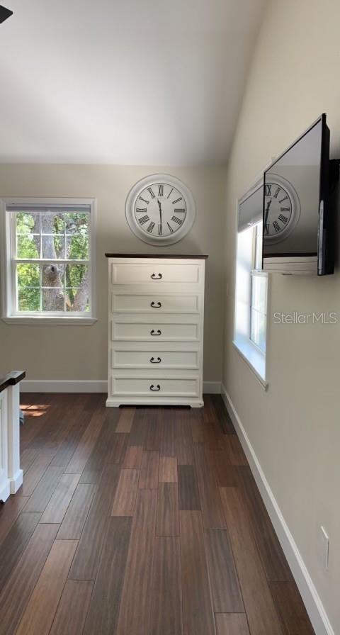 7152 Sandy Ln, Wesley Chapel, FL 33544 - spare room with healthy amount of natural light, dark wood-style floors, and baseboards