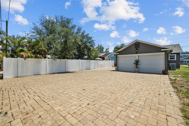 475 28th Ave N, Saint Petersburg, FL 33704 - view of side of property featuring central air condition unit and decorative driveway