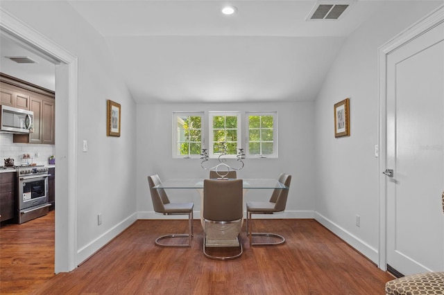 475 28th Ave N, Saint Petersburg, FL 33704 - dining space with vaulted ceiling, wood finished floors, and baseboards