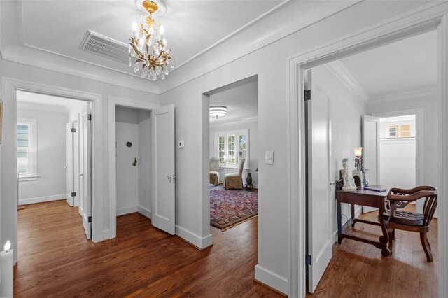 475 28th Ave N, Saint Petersburg, FL 33704 - hall featuring a chandelier, wood finished floors, baseboards, ornamental molding, and an office area