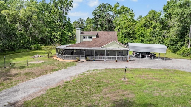 1611 County Road 753s, Webster, FL 33597 - view of front of home with driveway, a front yard, a sunroom, and a detached carport