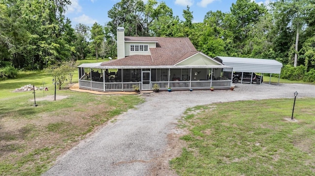 1611 County Road 753s, Webster, FL 33597 - view of front of home featuring dirt driveway, a sunroom, a front yard, a chimney, and a detached carport