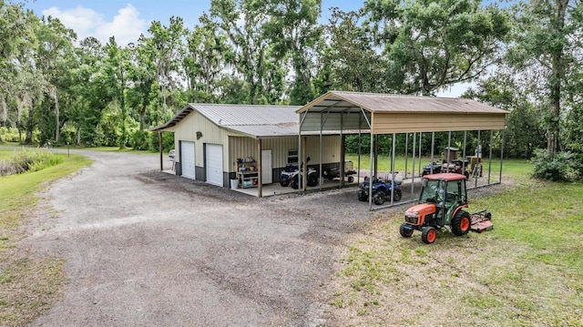 1611 County Road 753s, Webster, FL 33597 - exterior space featuring an outdoor structure, a detached garage, a lawn, view of wooded area, and driveway
