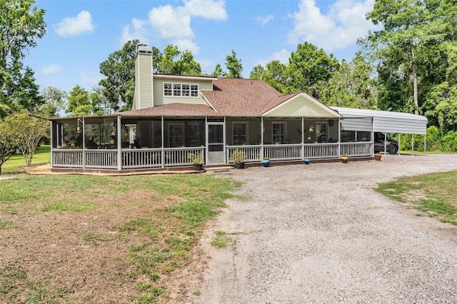 1611 County Road 753s, Webster, FL 33597 - view of front of house with dirt driveway, a sunroom, a chimney, a shingled roof, and a front yard
