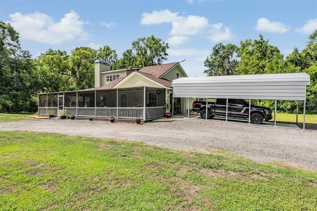 1611 County Road 753s, Webster, FL 33597 - view of front of home with a detached carport, gravel driveway, a sunroom, and a front yard