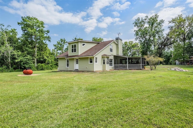 1611 County Road 753s, Webster, FL 33597 - rear view of house with a sunroom, a yard, a chimney, and a shingled roof