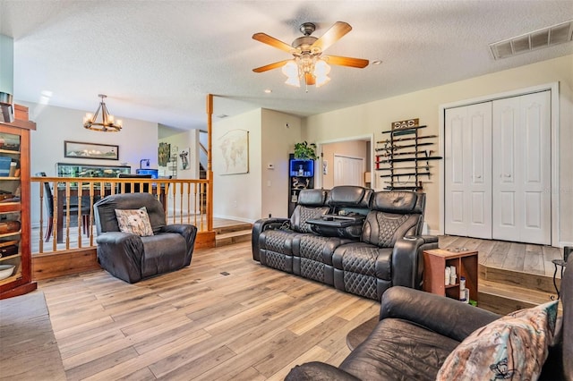 1611 County Road 753s, Webster, FL 33597 - living area featuring wood finished floors, a chandelier, ceiling fan, a textured ceiling, and stairs