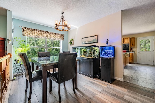 1611 County Road 753s, Webster, FL 33597 - dining area with a chandelier, light wood-style flooring, and a textured ceiling