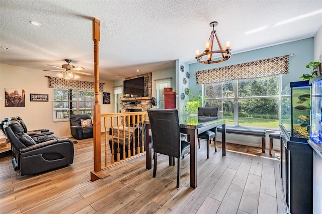 1611 County Road 753s, Webster, FL 33597 - dining area with light wood-style floors, plenty of natural light, a chandelier, ceiling fan, and a textured ceiling