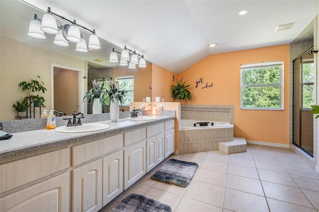 1611 County Road 753s, Webster, FL 33597 - bathroom featuring a shower stall, a garden tub, double vanity, plenty of natural light, and a textured ceiling