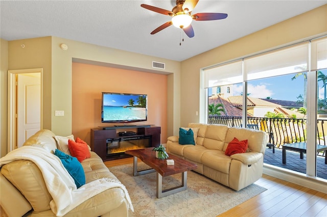 521 Mandalay Ave Unit 307, Clearwater Beach, FL 33767 - living room with light wood finished floors and ceiling fan