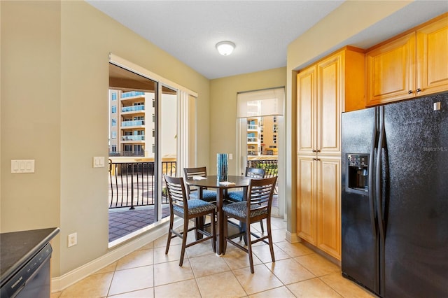 521 Mandalay Ave Unit 307, Clearwater Beach, FL 33767 - dining space featuring healthy amount of natural light, light tile patterned flooring, and baseboards