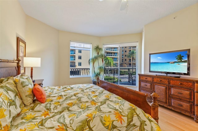 521 Mandalay Ave Unit 307, Clearwater Beach, FL 33767 - bedroom with access to exterior, light wood-type flooring, and ceiling fan