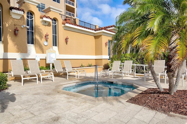 521 Mandalay Ave Unit 307, Clearwater Beach, FL 33767 - view of swimming pool featuring a hot tub, a patio area, and a swimming pool
