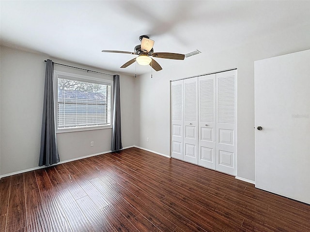 507 E Curlew Pl, Tarpon Springs, FL 34689 - unfurnished bedroom featuring wood finished floors, a closet, a ceiling fan, and baseboards