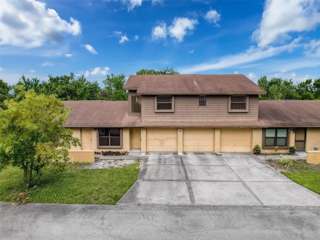 507 E Curlew Pl, Tarpon Springs, FL 34689 - view of front of property featuring brick siding, driveway, an attached garage, and roof with shingles