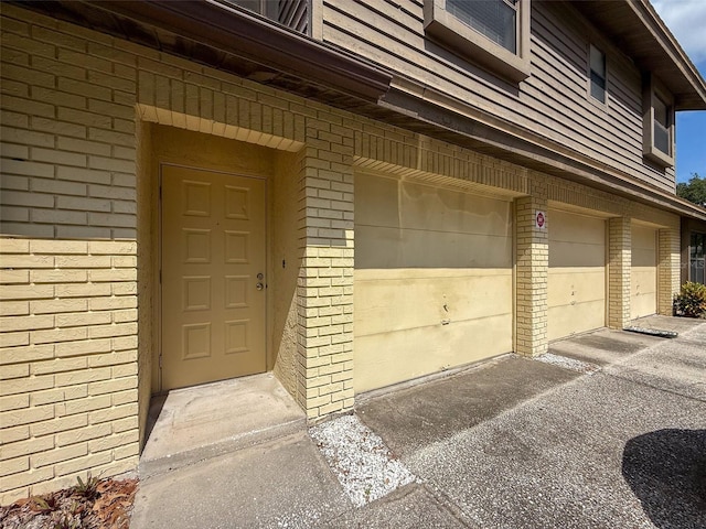 507 E Curlew Pl, Tarpon Springs, FL 34689 - property entrance with brick siding and a garage