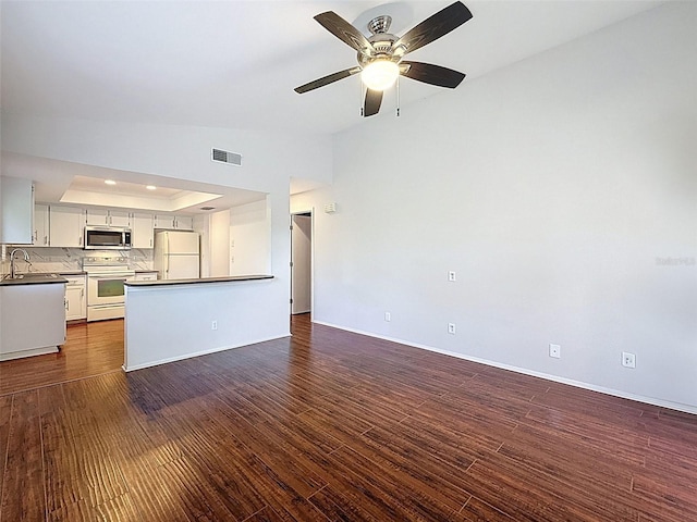507 E Curlew Pl, Tarpon Springs, FL 34689 - unfurnished living room featuring ceiling fan, dark wood-style flooring, a sink, baseboards, and recessed lighting