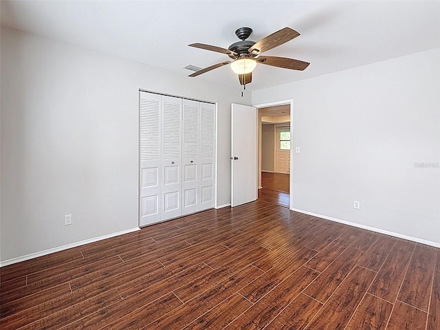 507 E Curlew Pl, Tarpon Springs, FL 34689 - unfurnished bedroom with wood finished floors, a closet, ceiling fan, and baseboards