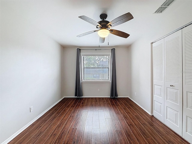 507 E Curlew Pl, Tarpon Springs, FL 34689 - unfurnished bedroom with wood finished floors, a closet, baseboards, and a ceiling fan