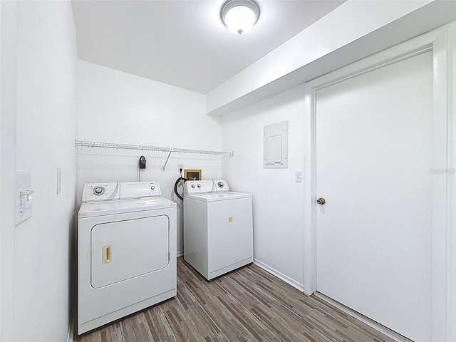 507 E Curlew Pl, Tarpon Springs, FL 34689 - washroom featuring independent washer and dryer, wood finished floors, electric panel, and baseboards