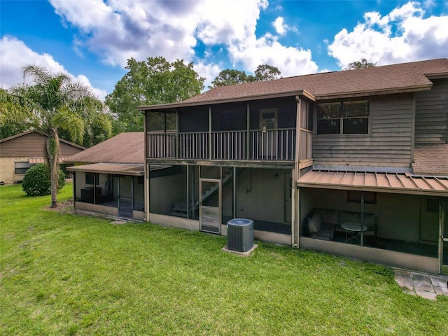 507 E Curlew Pl, Tarpon Springs, FL 34689 - rear view of property with a sunroom, cooling unit, a yard, a standing seam roof, and a shingled roof