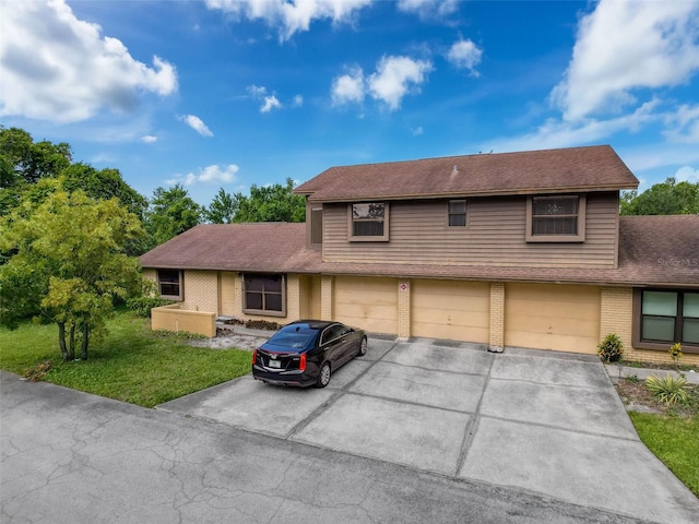 507 E Curlew Pl, Tarpon Springs, FL 34689 - view of front facade featuring driveway, brick siding, a garage, a shingled roof, and a front lawn