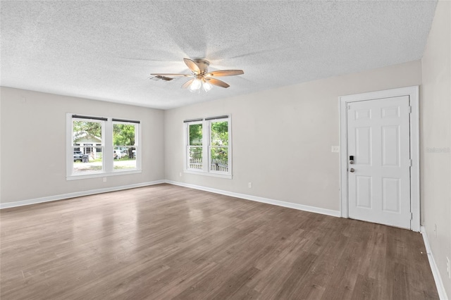 6489 30th St N, Saint Petersburg, FL 33702 - unfurnished room with ceiling fan, wood finished floors, a textured ceiling, and baseboards
