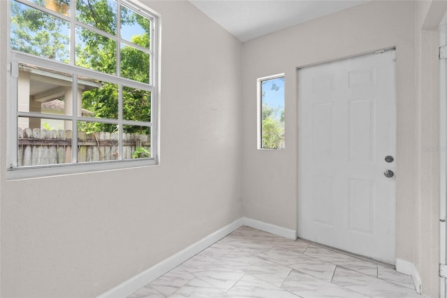 6489 30th St N, Saint Petersburg, FL 33702 - foyer featuring light marble finish flooring and baseboards