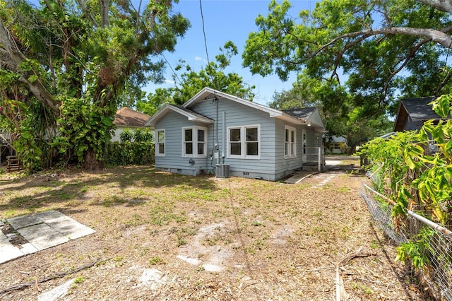 6489 30th St N, Saint Petersburg, FL 33702 - back of property with crawl space and central AC unit