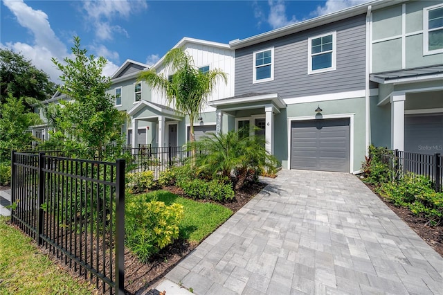 5530 N 9th St Unit 6, Tampa, FL 33604 - view of front facade featuring an attached garage, stucco siding, and decorative driveway