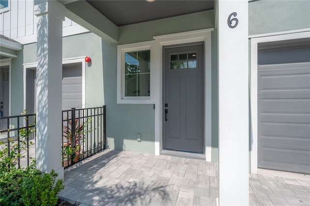 5530 N 9th St Unit 6, Tampa, FL 33604 - view of exterior entry featuring stucco siding, a garage, and a porch