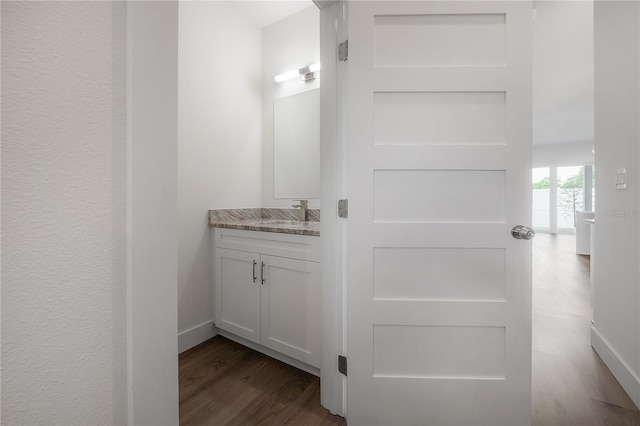 5530 N 9th St Unit 6, Tampa, FL 33604 - bathroom featuring wood finished floors, vanity, and baseboards