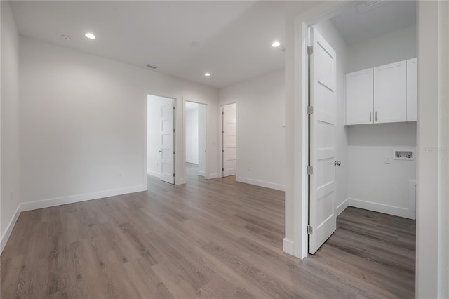 5530 N 9th St Unit 6, Tampa, FL 33604 - washroom featuring washer hookup, baseboards, wood finished floors, recessed lighting, and cabinet space