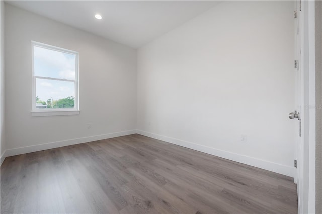5530 N 9th St Unit 6, Tampa, FL 33604 - spare room featuring wood finished floors, baseboards, and recessed lighting