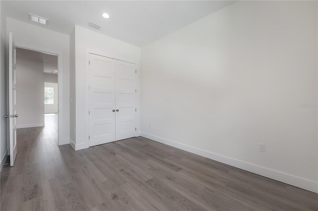 5530 N 9th St Unit 6, Tampa, FL 33604 - unfurnished bedroom with wood finished floors, baseboards, a closet, and recessed lighting