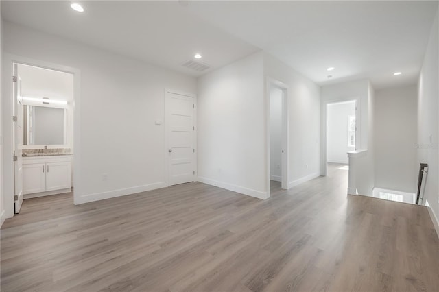 5530 N 9th St Unit 6, Tampa, FL 33604 - empty room with light wood-style flooring, recessed lighting, baseboards, and a sink