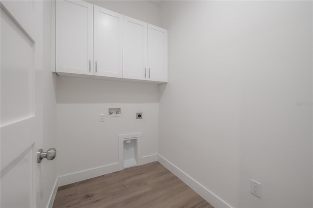 5530 N 9th St Unit 6, Tampa, FL 33604 - washroom featuring electric dryer hookup, cabinet space, hookup for a washing machine, wood finished floors, and baseboards