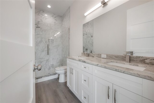 5530 N 9th St Unit 6, Tampa, FL 33604 - bathroom featuring a marble finish shower, double vanity, toilet, wood finished floors, and recessed lighting